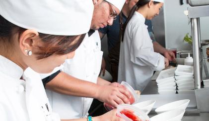 A group of chefs working in a professional kitchen