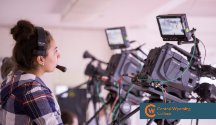 A student filming an athletic event.