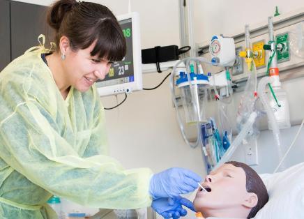 Nursing student practicing on a dummy