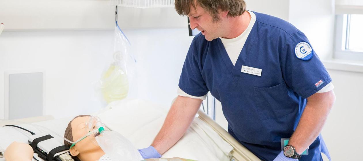 A nursing student working the simulation lab.