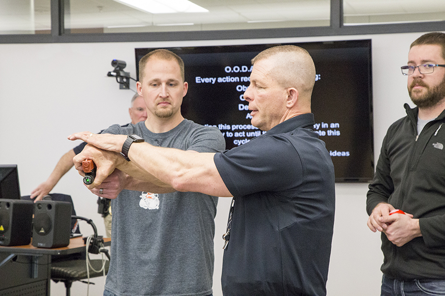 Trainer exhibiting defensive strategy for ALICE student