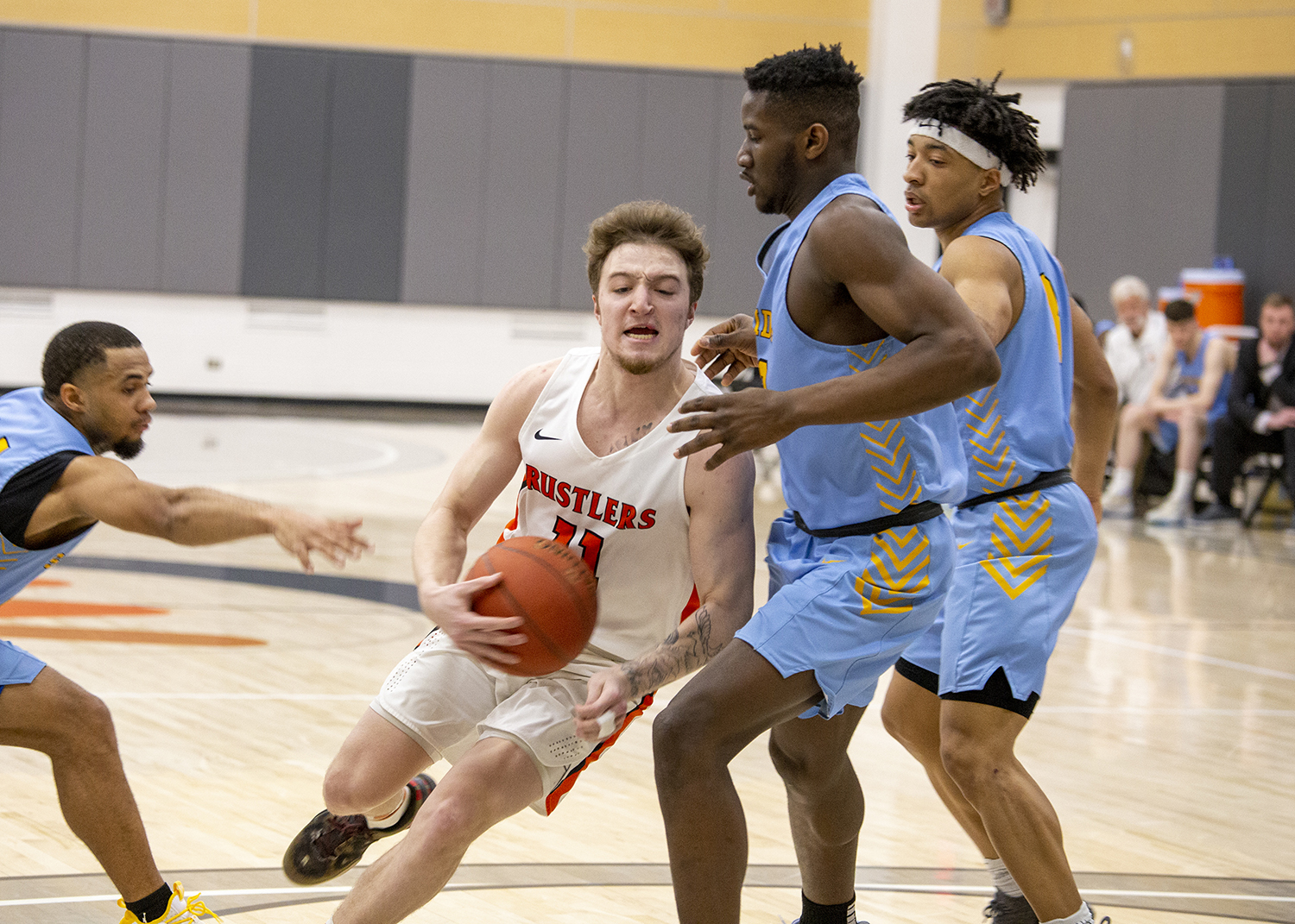 James Woods dribbles the ball around a Sheridan College player