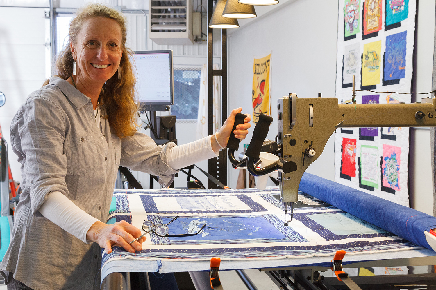 Catherine Neiley sewing a quilt in her shop