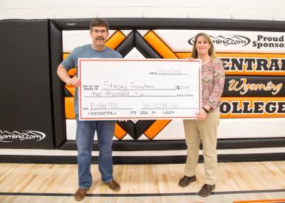 photo of Steve Barlow presenting a giant check for $2,000 to Rustler 400 winner Stacey Gaudern