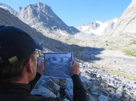 CWC ICCE student compares a historical photo with the location he is in, in the Wind River Mountains