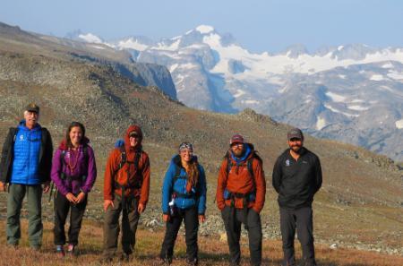 student standing in the Wind River range where Fourt once stood with his pack team
