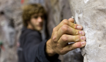 A student climbing in the CWC rock wall